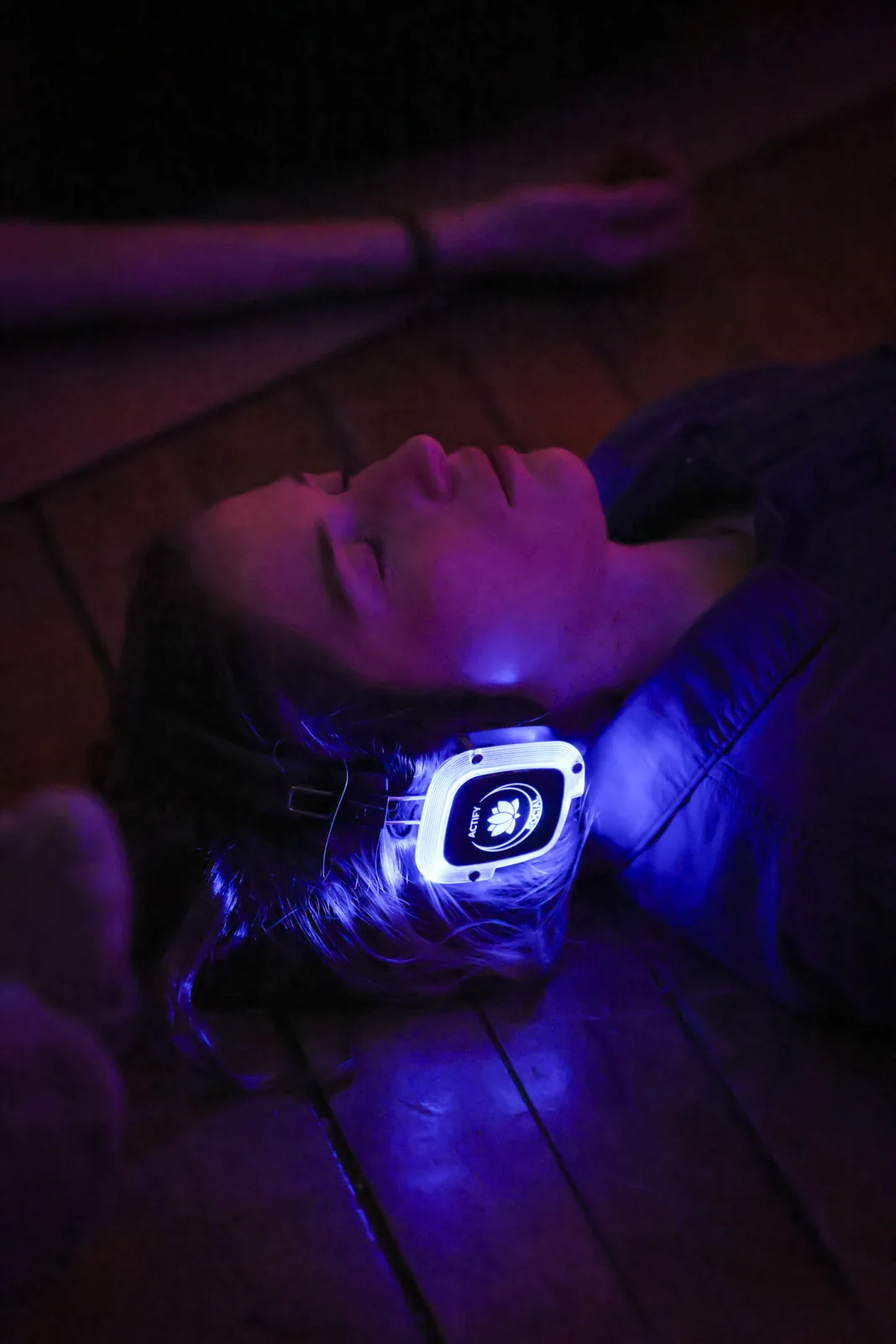 A rider lying down, headphones glowing
